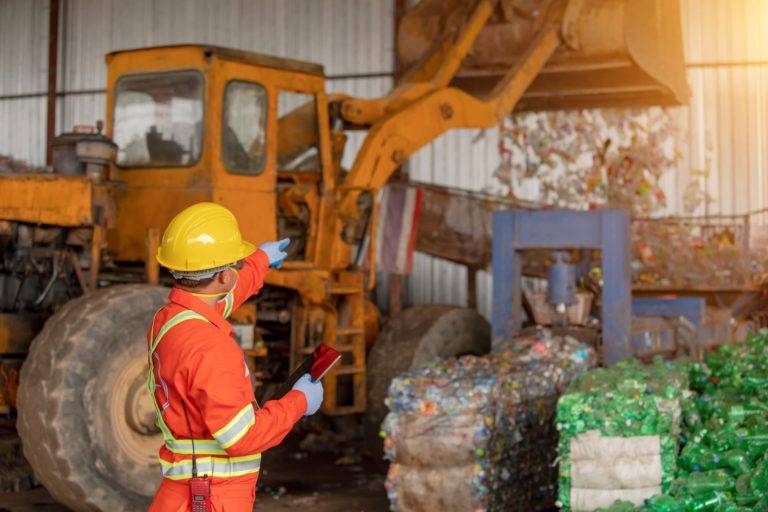 an operator managing waste in a depot