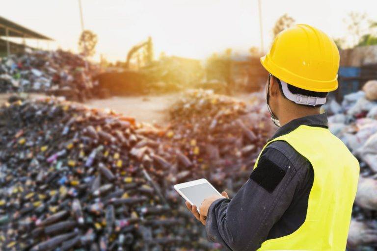 a surveyor monitoring waste management processes